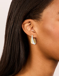Showcasing mixed metal plated layered small hoop earrings in gold and silver on ear view - link has visual effect only