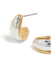 Highlighting small teardrop drop earrings crafted from mixed metal with gold plated and silver plated finishes close up view - link has visual effect only