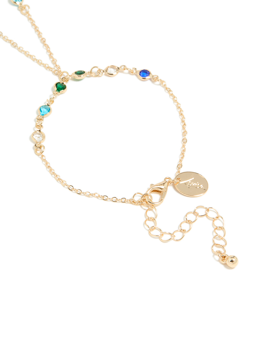 Highlighting the adjustable clasp detail of a statement hand chain in multicolor diamantes with green, red, and blue stones closure detail view