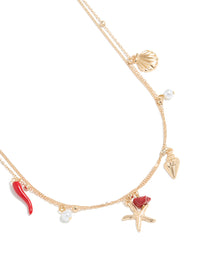 Crafted in gold, this ball and shell charm layered waist chain features pearl accents, embellished detailing, and an ocean-inspired design in detail view - link has visual effect only
