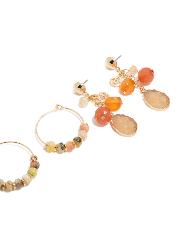 Featuring gold beaded hoop and drop earrings 3-pack with charms in hoop closure, showcasing orange, tan, and coral details post detail view