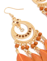 Highlighting statement drop earrings featuring beads, and coral feathers with gold detailing close up view - link has visual effect only