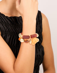 Showcasing beaded stretch bracelets in a 2-pack with irregular acrylic and gold accents in maroon, orange, and peachpuff tones, on wrist view - link has visual effect only