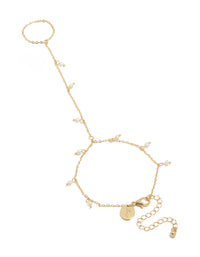 Discover this gold plated mini freshwater pearl droplet hand chain featuring charm accents in dainty statement style front view - link has visual effect only