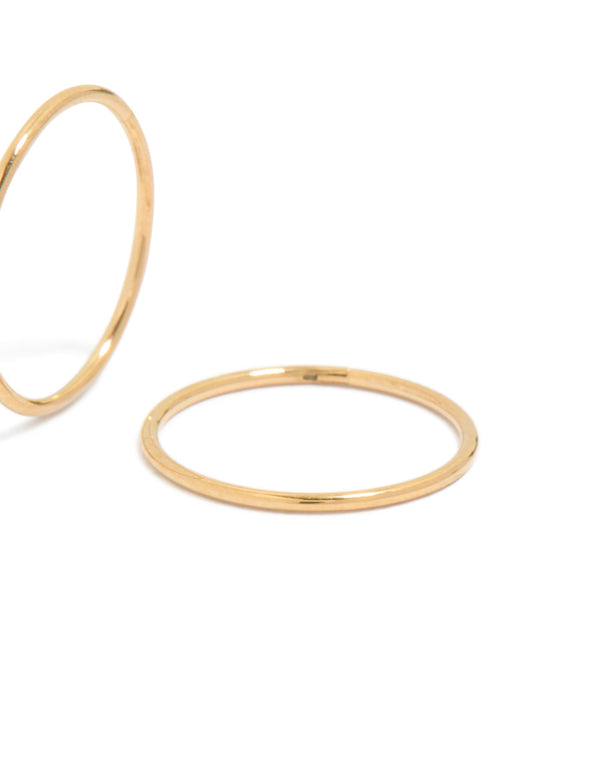 Highlighting 12 MM sleeper hoop earrings crafted from gold plated surgical steel in close up view