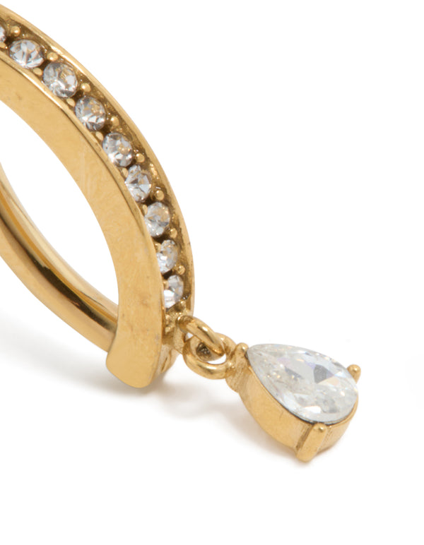 Featuring gold plated titanium belly ring with cubic zirconia charm and dainty curved drop design close up view