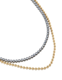 Showcasing a mixed metal plated cubic zirconia double layered tennis ball chain necklace with delicate gold detailing close up view - link has visual effect only