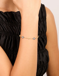 Crafted from mixed metal gold plated finish with cubic zirconia stones and ball chain design bracelet on wrist view - link has visual effect only