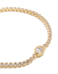 Highlighting a gold plated cubic zirconia oval tennis bracelet with clear stones close up view - link has visual effect only