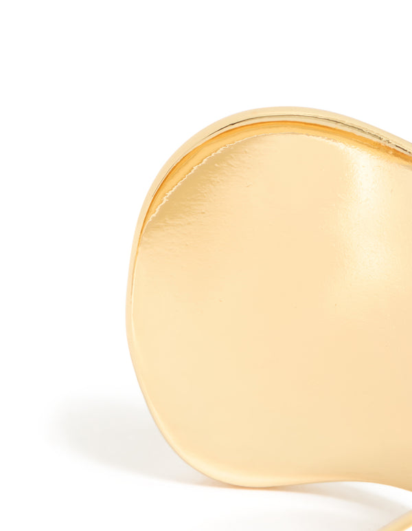 Crafted from gold plated material, this wide organic wrist cuff features statement bangle design closure detail view