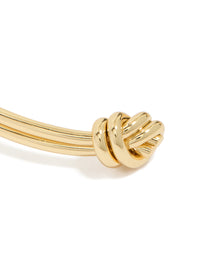 Detailed view of gold plated double knotted centre wrist cuff showcasing statement design close up view - link has visual effect only