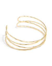 Crafted from gold plated material, this multi cross textured arm cuff features a statement style in gold front view - link has visual effect only