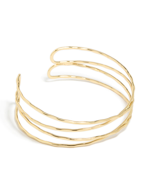 Crafted from gold plated material, this multi cross textured arm cuff features a statement style in gold front view
