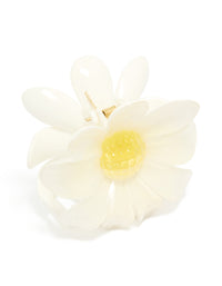 Showcasing a glossy daisy flower claw clip with in ivory, yellow side view - link has visual effect only