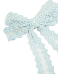 Showcasing floral fabric bow hair clip in light blue with textured knot center, detail view - link has visual effect only