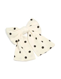 Showcasing a white and black polka dot fabric bow hair clip front view - link has visual effect only