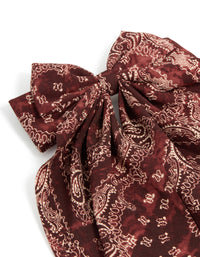 Elegant bow hair clip with paisley print in maroon, brown featuring statement design side view - link has visual effect only