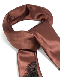 Crafted from chocolate brown fabric, this long scarf features solid print with black lace edge detail view - link has visual effect only