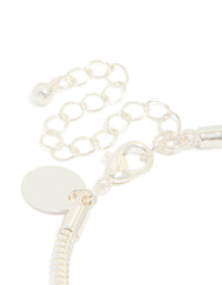Highlighting the dainty silver plated bow charm bracelet with cubic zirconia and heart details on closure detail view - link has visual effect only