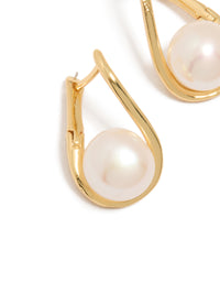 Featuring gold plated freshwater pearl twist hoop earrings with ivory accents close up view - link has visual effect only