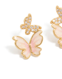 Capturing small butterfly stud earrings in gold plated finish with pink enamel and cubic zirconia close up view - link has visual effect only