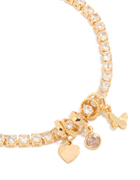Featuring a gold plated cubic zirconia mixed charm tennis bracelet with butterfly and heart details close up view - link has visual effect only