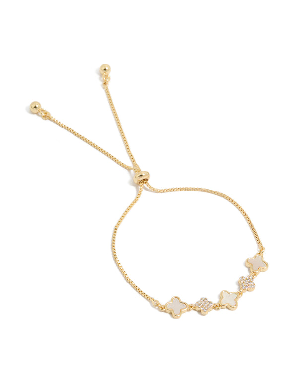 This gold plated bracelet features floral details with cubic zirconia and plain white inlay, complete with a toggle closure front view