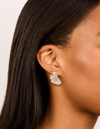 Crafted from rose gold plated material, these diamante pink half flower earrings feature with glitter and stud closure on ear view - link has visual effect only