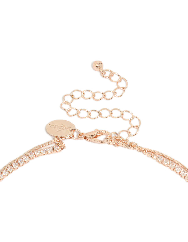 Highlighting a rose gold plated cubic zirconia cup chain and snake layered Y-necklace with crystal accents clasp detail view