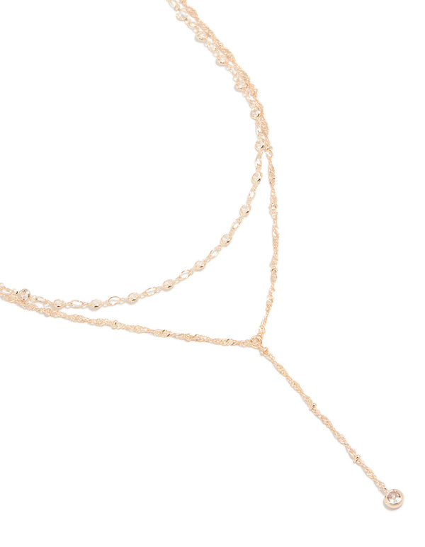 Stunning rose gold plated cubic zirconia bezel set layered chain Y-necklace with statement styling close up view