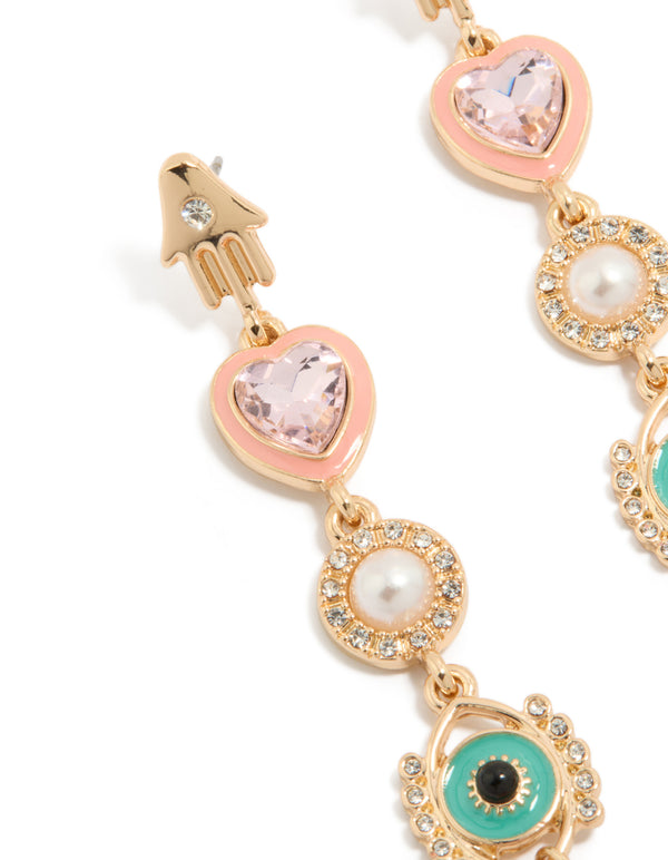 Featuring gold enamel celestial drop earrings with evil-eye, pearl, heart, hamsa hand and charm details in pink and turquoise, statement style close up view