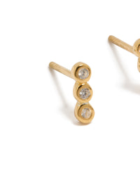 Featuring gold plated sterling silver cubic zirconia bezel trio drop stud earrings with clear accents close up view - link has visual effect only