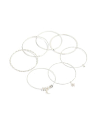 Showcasing celestial charm bangles featuring diamante moon and star accents in a statement 7-pack set front view - link has visual effect only