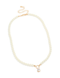 Featuring a gold cubic zirconia dainty pearl pendant necklace in a front view - link has visual effect only