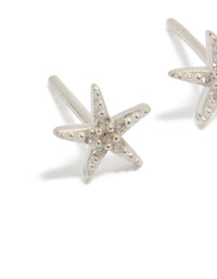Featuring dainty sterling silver cubic zirconia starfish earrings with ocean-inspired design close up view - link has visual effect only