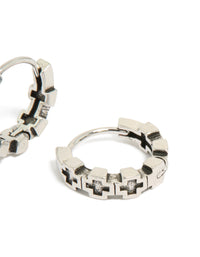 Designed with waterproof brushed stainless steel and multi cross detailing, these mens huggie hoop earrings in silver and black post detail view - link has visual effect only
