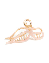 Featuring a bow claw clip with solid pink and gold accents side view - link has visual effect only