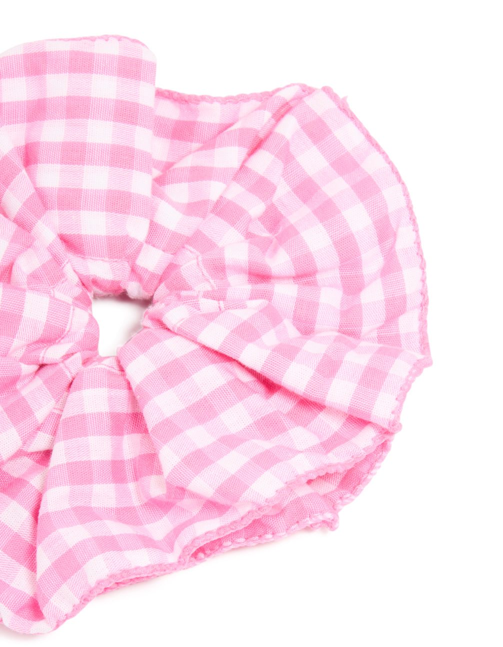 Designed with checkered fabric, this ruffled scrunchie in pink and white side view