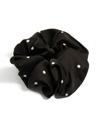 Showcasing a statement scrunchie in micro polka dot pattern with black and white fabric front view - link has visual effect only