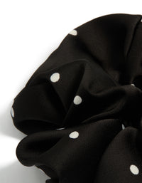Designed with micro polka dot pattern, a statement scrunchie in black and white fabric side view - link has visual effect only