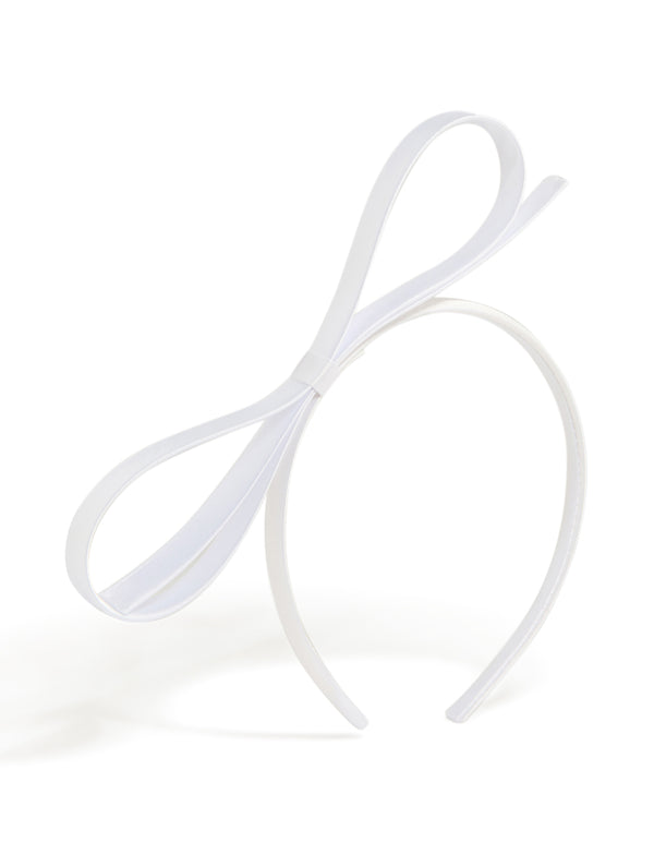 Showcasing a white thin bow headband with dainty in solid front view
