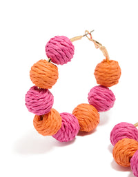 Beautifully crafted statement hoop earrings featuring paper balls in hot pink, coral and gold close up view - link has visual effect only