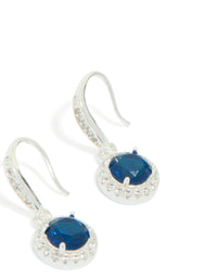 Elegant drop earrings featuring sapphire blue cubic zirconia with halo cut and plated finish close up view - link has visual effect only