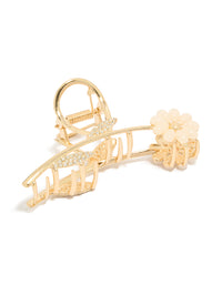 Showcasing a floral resin claw clip with leaf accents featuring diamante embellishments in pink and white on gold side view - link has visual effect only