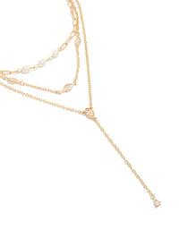 Showcasing a gold plated cubic zirconia and freshwater pearl triple layered Y-necklace in dainty style close up view - link has visual effect only