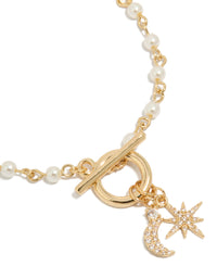 Beautifully crafted gold plated pearl and cubic zirconia bracelet with celestial star moon charm fob close up view - link has visual effect only