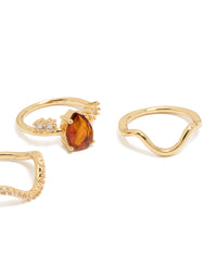 Featuring gold plated red cubic zirconia teardrop and wavy rings 3-pack with crystal embellishments in statement style close up view - link has visual effect only