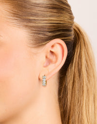 Elegant waterproof huggie earrings with round bezel set cubic zirconia stones in gold plated stainless steel on ear view - link has visual effect only