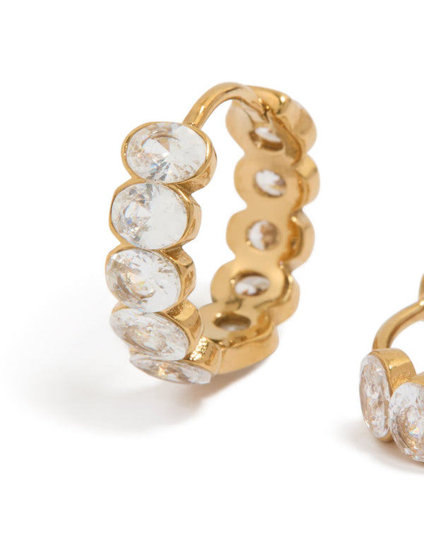 Detailed view of waterproof huggie earrings with round bezel set cubic zirconia stones in gold plated stainless steel close up view