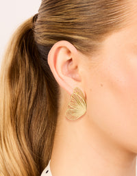 Featuring waterproof laser cut butterfly stud earrings in gold plated stainless steel on ear view - link has visual effect only